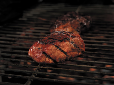 Grilled pork rib on a grill's cooking grid.
