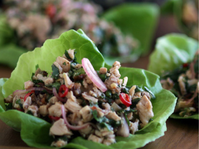 Finished salads on a wooden serving plate.