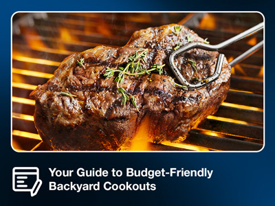 Metal tongs holding a grilled beef steak over the cooking grids of a standup propane grill.