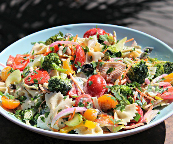 Finished salad in a light blue bowl.
