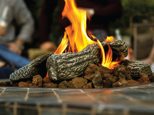 Closeup of a lit propane fire pit.