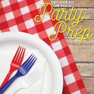 Closeup of red, white, and blue forks on a white paper plate, sitting on a red and white checkered table cloth on a wooden table.