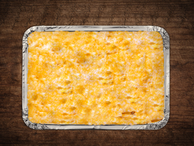 Closeup of the cheesy beer potatoes in an aluminum service tray.