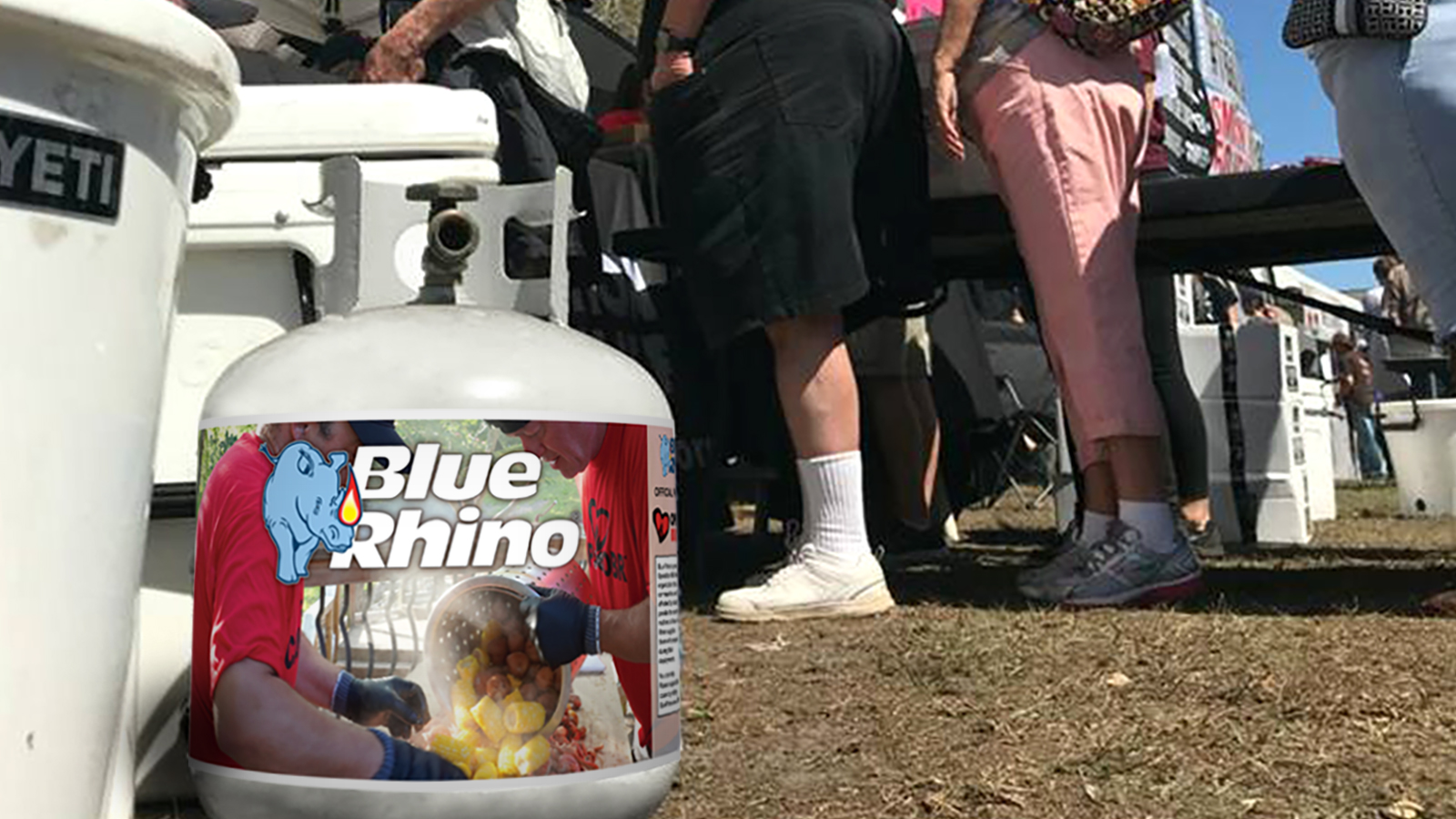 Fresh Blue Rhino tank sitting on the ground with people in the background.