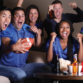 Friends wearing blue jerseys cheering on their favorite team.