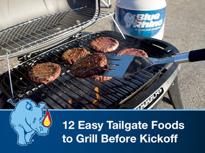 Portable gas grill on the pavement grilling burgers, with a Blue Rhino tank in the background.