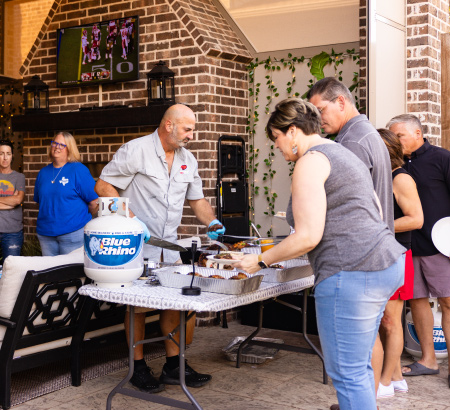 Chef serving freshly grilled food to guests.