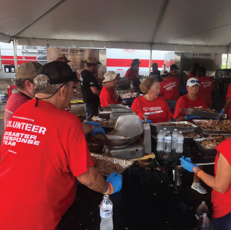 Photo of Operation BBQ Relief Volunteers making meals.