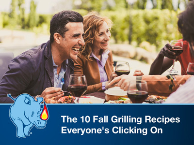 Friends sitting around a table outside, eating grilled food.