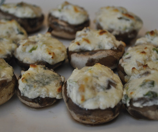 Stuffed mushrooms on a white table.