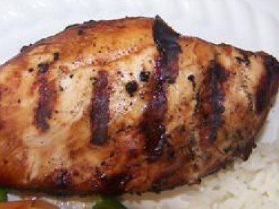 Grilled chicken on a white plate.