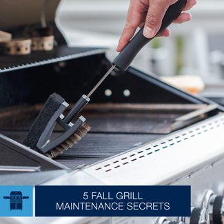 Closeup of a man using a double sided grill brush to clean the cooking grids on a standup propane grill.