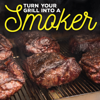 Closeup of grilled beef steaks on the cooking grids of a standup propane grill.