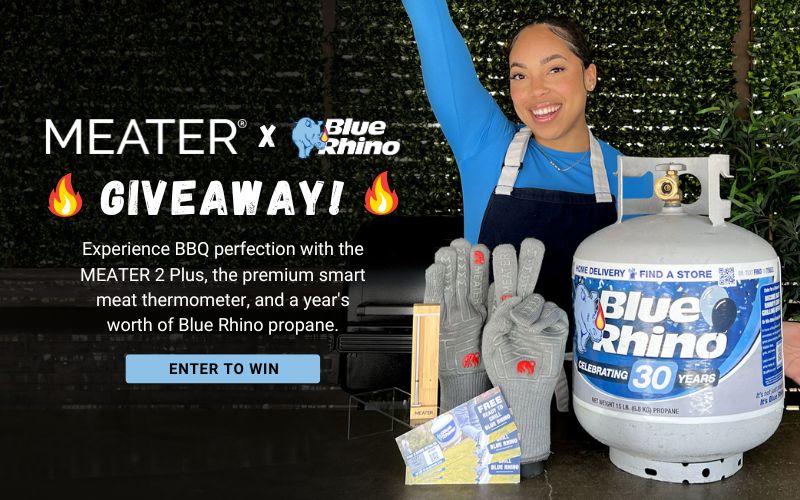 Woman standing behind a table with a Blue Rhino tank, Meater gloves, thermometer and Blue Rhino free tank exchange coupons.